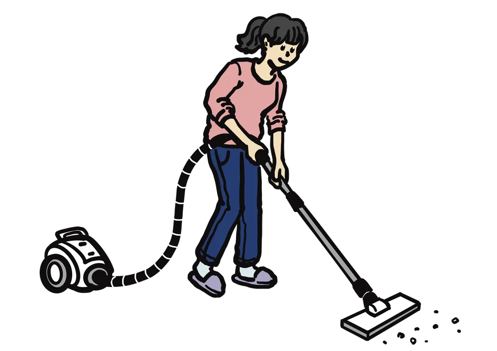 掃除機をかける女性。ゴミを吸い取る様子。